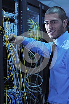 Young it engineer in datacenter server room