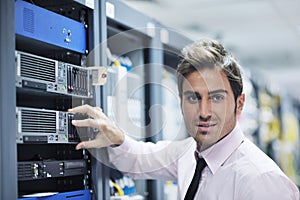 Young it engineer in datacenter server room