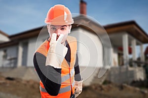 Young engineer doing look into my eyes sign