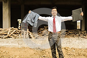 An young engineer in formal suit and pant with portfolio near a construction site feeling confident and celebrating joy