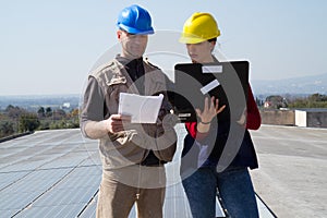 Young engineer girl and skilled worker on a roof