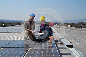 Young engineer girl and skilled worker on a roof photo