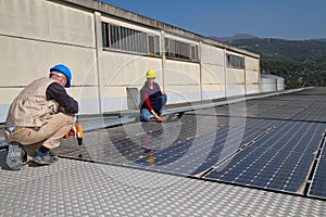 Young engineer girl and skilled worker on a roof