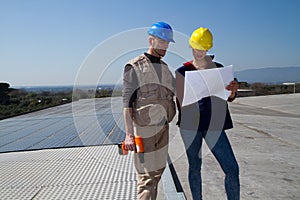 Young engineer girl and skilled worker on a roof