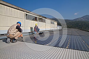 Young engineer girl and skilled worker on a roof