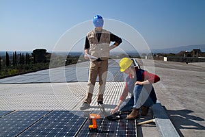 Young engineer girl and skilled worker on a roof