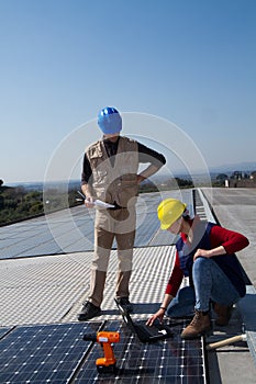 Young engineer girl and skilled worker on a roof