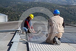 Young engineer girl and skilled worker on a roof