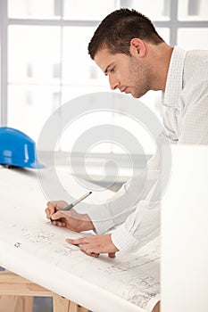 Young engineer making plans