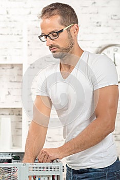 Young engineer repaired a computer