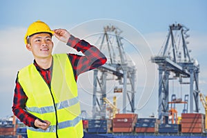 Engineer with safety helmet with industrial port containers background