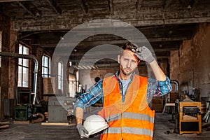 Young engineer standing indoors an old woodworking plant