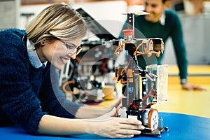 Young engineer testing her robot in workshop