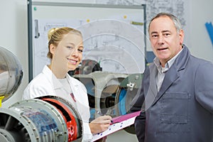 Young engineer testing robot in workshop