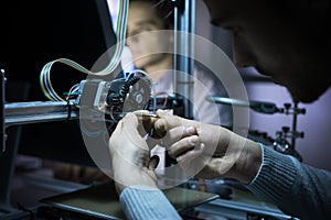 Young engineer working on a 3D printer