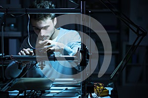 Young engineer working on a 3D printer