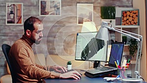 Young engineer working late at night in his home office