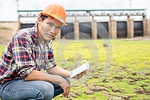 Young engineer working on site at the dam