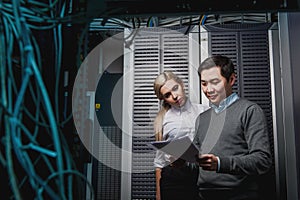 Young engineers businessmen in server room