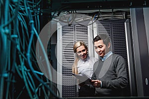 Young engineers businessmen in server room