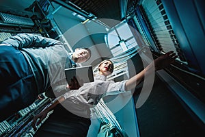 Young engineers businessmen in server room