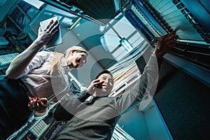 Young engineers businessmen in server room