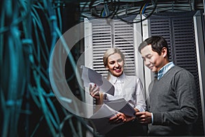 Young engineers businessmen in server room