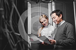 Young engineers businessmen in server room