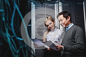 Young engineers businessmen in server room