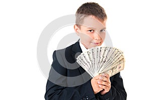 Young enterprising boy schoolboy in a business suit holding money in his hands. How to earn the first million dollars