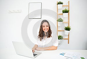 Young enterprising businesswoman working in her office photo