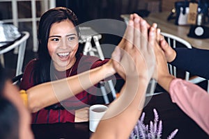 Young enthusiastic team giving high five