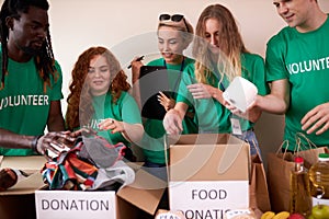 Young enthusiastic volunteers with donations for poor people