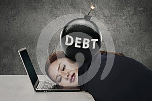 Young entrepreneur sleeps with debt bomb