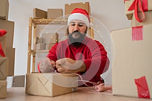 Young entrepreneur SME Santa Claus receive order client and working with packaging box delivery online market preparing