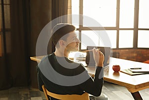 Young Entrepreneur Thinking Holding Pencil Working Sitting At Workdesk Indoors