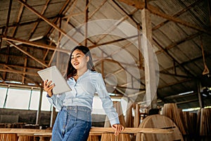 young entrepreneurial woman using a computer tablet in workshop