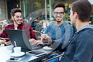 Young entrepreneurs working at coffee bar.