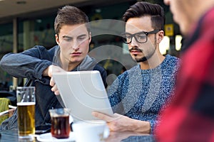 Young entrepreneurs working at coffee bar.