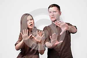 Young european couple showing refusal gesture to stop