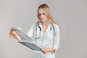 Young European Doctor Examines the Anamnesis, Medical Record of the Patient.