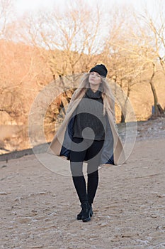 Young european girl dressed in fashionable sweater and coat