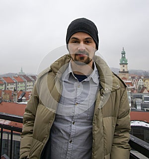 Young european student on blurry city background. Research and future looking to camera concept