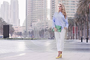 Young european woman with curly blond hair and trendy make up st