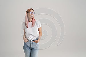 Young european woman in eyeglasses smiling and looking aside