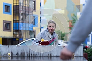 Young european woman playing table tennis in yard