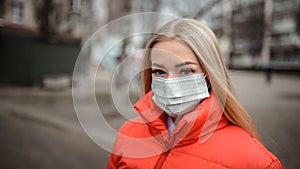 Young European woman in a protective mask from coronavirus in the city. healthcare and air pollution concept