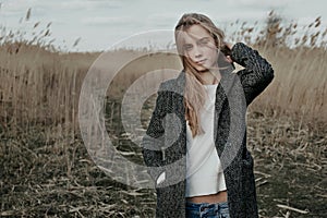 Young european woman standing on country road photo