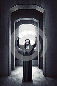 Young evil asian woman nun standing with white pentagram