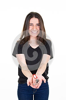 Young excited happy woman showing holding home key isolated on white background